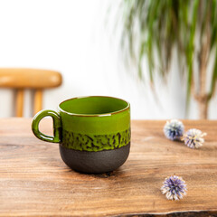 handmade ceramic coffee cup on wooden table
