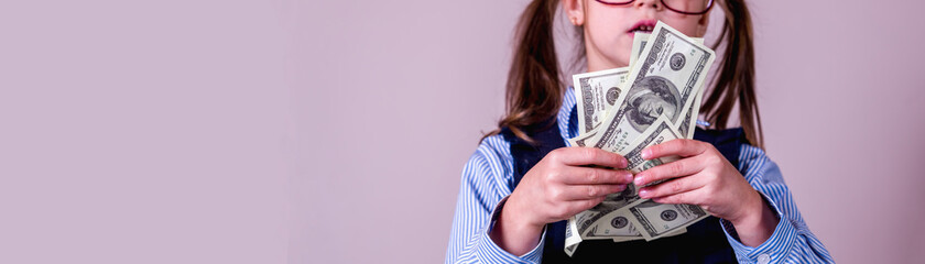 Money is the best motivation. Portrait of young beautiful business girl  holding US Dollars banknotes.