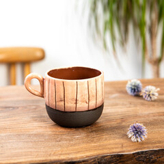 handmade ceramic coffee cup on wooden table