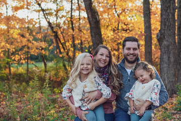 Fototapeta premium Happy young family at the park on a fall day