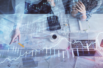 Double exposure of man and woman working together and financial graph hologram drawing. market analysis concept. Computer background. Top View.