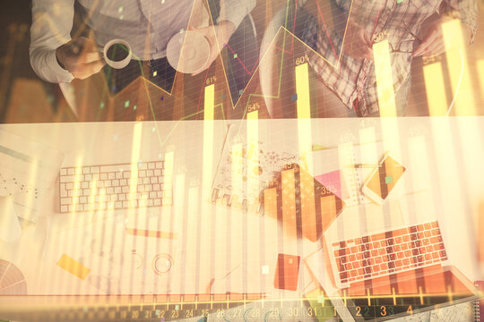 Double exposure of man and woman working together and financial chart hologram drawing. market analysis concept. Computer background. Top View. © peshkova