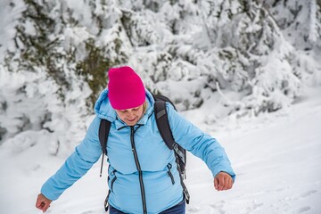 Fototapeta na wymiar woman with backpack in winter snowy forest