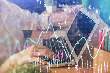 Double exposure of woman hands typing on computer and forex chart hologram drawing. Stock market invest concept.