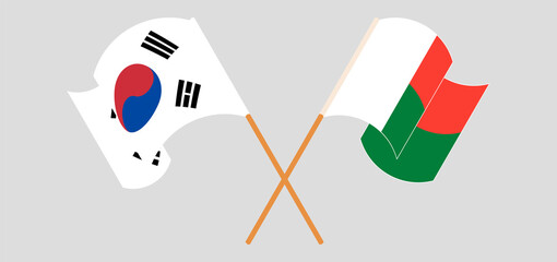 Crossed and waving flags of Madagascar and South Korea