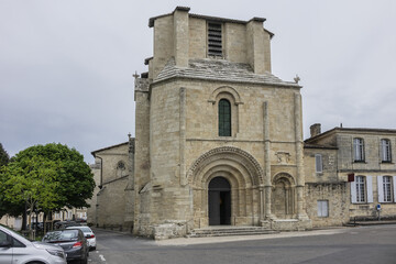 Fototapeta na wymiar XII century Romanesque style Eglise Collegiale on St Emilion’s Place Pierre Meyrat. SAINT-EMILION, BORDEAUX, FRANCE. April 14, 2019.