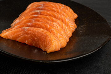 Slices of Raw Salmon Fillet on Black Background Mockup Top View