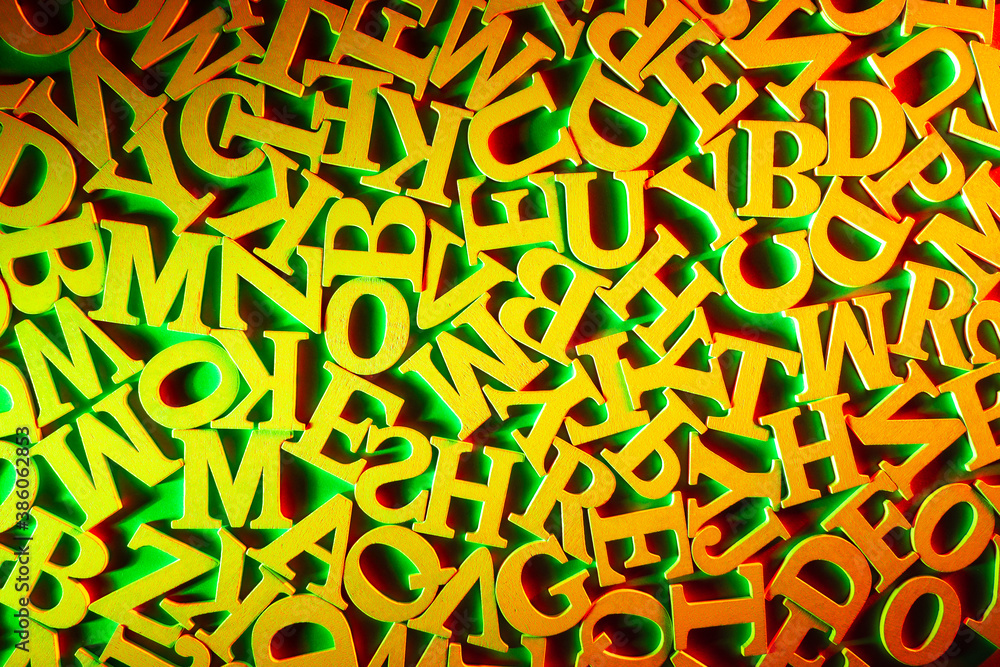 Fototapete school and learning theme. yellow latin letters on a green background. english letters in random ord