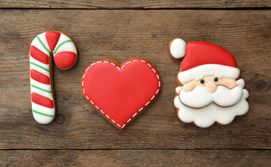 Different delicious Christmas cookies on wooden table, flat lay