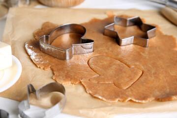 Making homemade Christmas cookies. Dough and cutters on table, closeup
