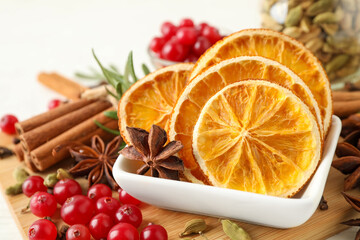 Composition with mulled wine ingredients on wooden board, closeup