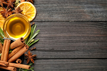 Flat lay composition with mulled wine ingredients on black wooden table. Space for text