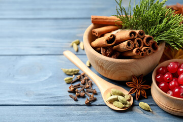 Composition with mulled wine ingredients on blue wooden table, closeup. Space for text