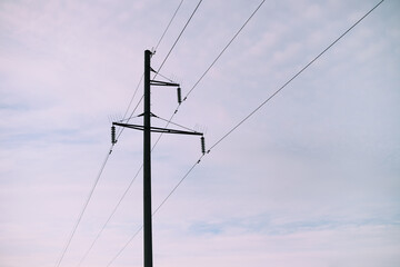 Closeup of old power poles on a cloudy autumn day