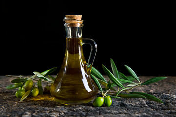 olive oil and fresh olives on the old table