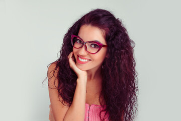 smiling woman in eyeglasses posing hand on chin