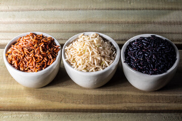 Black venus, red and integral rice pile isolated on wooden table background in Brazil