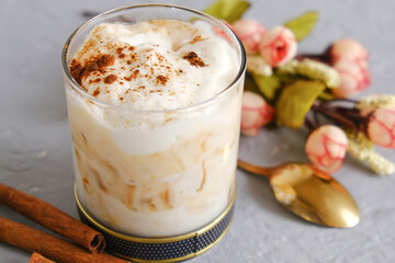 Glass of homemade yogurt with cinnamon and caramel. Tasty sweet dessert.