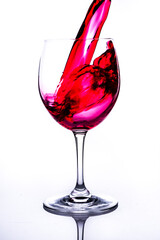 
glass with red liquid with white background