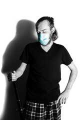 Man wearing a disposable mask and katana sword. Medical mask color isolated portrait. Fighting off Covid-19 pandemic concept. Determination and praying for world health