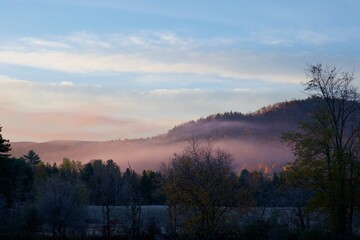 Pink mist over a hill on a cold morning in late fall