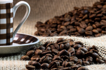 cup of coffee and grain coffee beans on jute background in Brazil