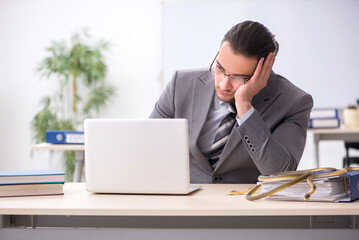 Young male employee with snake in the office