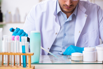 Young male chemist working in the lab