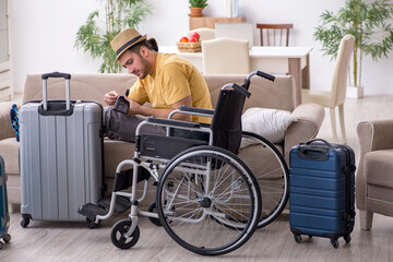 Young man in wheel-chair preparing for departure at home