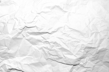 white and gray crumpled paper texture background. crush paper so that it becomes creased and...