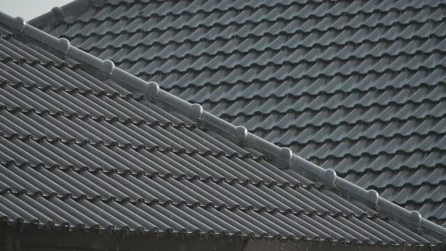 slow motion rain storm in rainy day weather, droplet falling on roof house