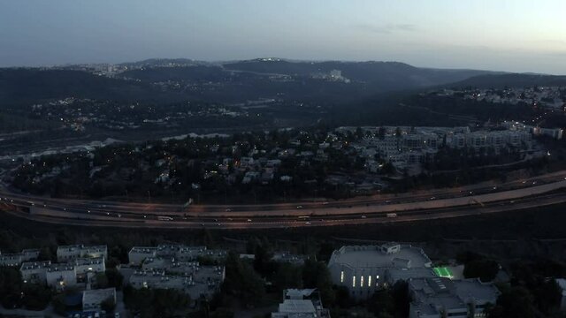 Jerusalem mountains at sunset with traffic aerial view
motza and beit zait with road one, drone footage
