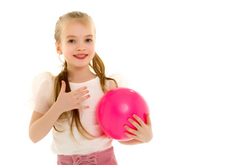 Fototapeta na wymiar little girl is engaged in fitness with a ball.