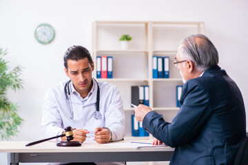 Fototapeta premium Male doctor in courthouse meeting with lawyer