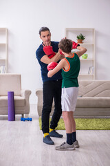 Fototapeta na wymiar Father and son doing sport exercises indoors