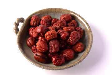 Dried jujube in a plate on a white background
