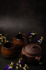 Obraz na płótnie Canvas Antique brown chinese tea set on black background