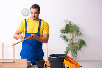 Young male carpenter working indoors