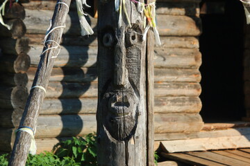 old wood carved face on a pillar