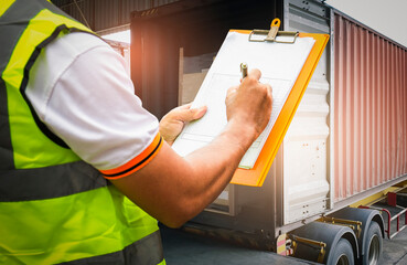 Cargo freight truck, Shipment, Delivery service. Worker holding clipboard his control loading cargo pallet boxes into shipping container. Logistics and transportation.