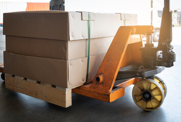 Hand pallet truck and cargo boxes pallet shipment. 