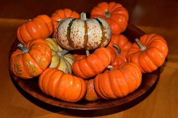 Pumpkins and gourds in a wooden bowl