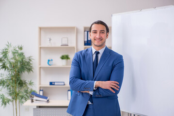 Fototapeta premium Young man employee in business presentation concept