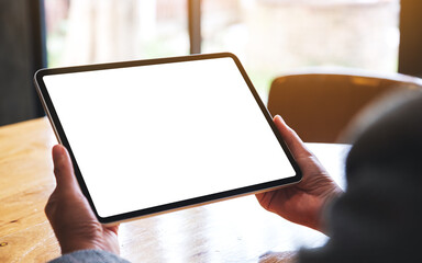 Mockup image of a woman holding digital tablet with blank white desktop screen