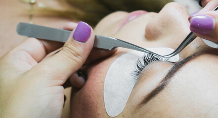 Eyelash Extension Procedure. Woman Eye with Long Eyelashes. Lashes, close up, selective focus.