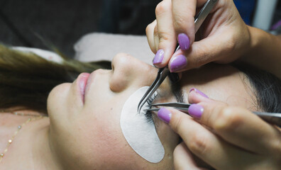 Eyelash Extension Procedure. Woman Eye with Long Eyelashes. Lashes, close up, selective focus.