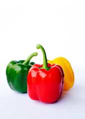 Red green yellow bell peppers raw food on white backgrounds