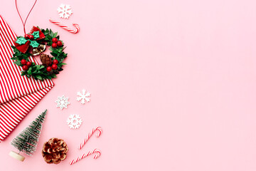 Fototapeta na wymiar Christmas composition. Christmas gifts, pine branches, toys on pink background. Flat lay, top view.