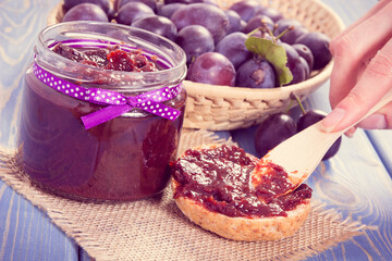 Preparing sandwiches with homemade plum marmalade or jam, sweet breakfast or dessert concept