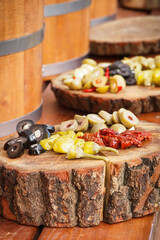 Fresh peppers and olives for sale at street market. Healthy food containing vitamins. Mediterranean snack